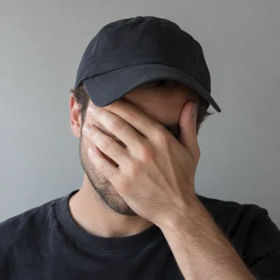 Face hidden by a hand